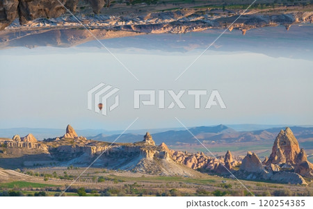 Welcome to amazing Cappadocia concept image. Unreal turned upside down landscape. Hot air balloon fly in morning sky in Cappadocia, Turkey. 120254385