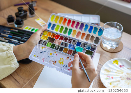 Artist Holding Watercolor Palette Preparing to Paint 120254663
