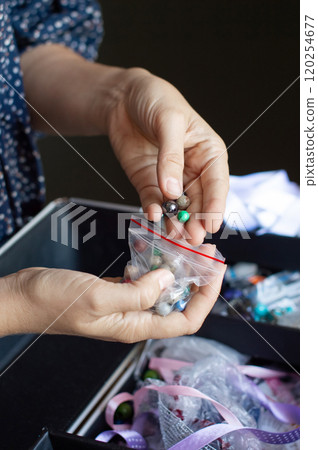Hand Picking Beads from a Selection for Craft Project Hand Picking Beads from a Selection for Craft Project 120254677