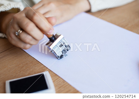 Hand Stamping Document on Desk: Legal, Approval, Office Setting Hand Stamping Document on Desk: Legal, Approval, Office Setting 120254714