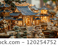 A miniature village with traditional Chinese architecture, illuminated by warm lights 120254752