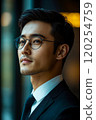 A man in glasses and a suit looking to the side 120254759