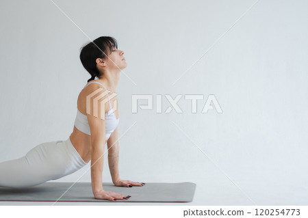 Yoga fitness workout training. Woman practicing yoga isolated on white background. Woman doing sports exercise on yoga mat. Girl in sportswear have training workout for weight loss. Sport and fitness Yoga fitness workout training. Woman practicing yoga isolated on white background. Woman doing sports exercise on yoga mat. Girl in sportswear have training workout for weight loss. Sport and fitness 120254773