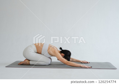 Yoga fitness workout training. Woman practicing yoga isolated on white background. Woman doing sports exercise on yoga mat. Girl in sportswear have training workout for weight loss. Sport and fitness Yoga fitness workout training. Woman practicing yoga isolated on white background. Woman doing sports exercise on yoga mat. Girl in sportswear have training workout for weight loss. Sport and fitness 120254774