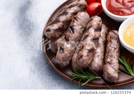 Grilled beef sausages with rosemary sauce and tomatoes photography . Top view Grilled beef sausages with rosemary sauce and tomatoes photography . Top view 120255374