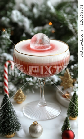 Festive cocktail served in elegant glass with seasonal decorations and ice sphere on top 120255572