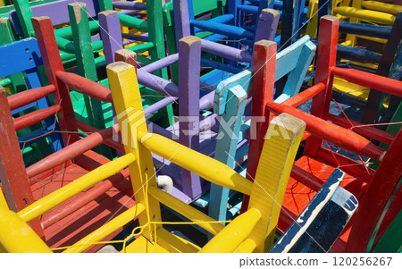 Vibrant colorful wooden chair legs, stacked upside down Vibrant colorful wooden chair legs, stacked upside down 120256267