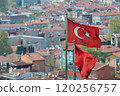 Turkish flags wave in wind above residential neighborhood in Istanbul, Turkey 120256757