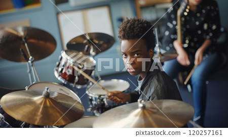The boy is studying at a music school. 120257161