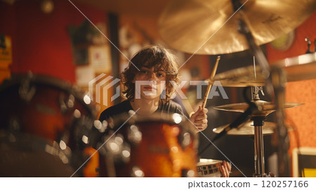 Playing drums at a music school. 120257166