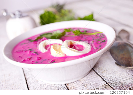Cold beetroot soup in bowl on wooden background Cold beetroot soup in bowl on wooden background 120257194