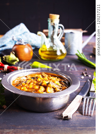 Vegetable stew. in metal bowl. Hot foodstuff. 120257211