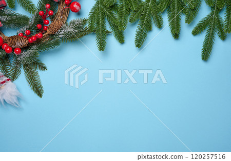 Spruce branches and Christmas toys on a blue background, top view 120257516