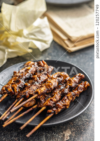 Japanese chicken yakitori on plate on black table. 120257749