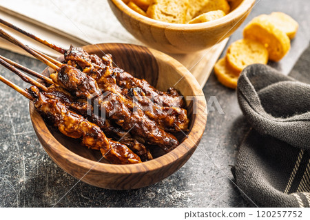 Japanese chicken yakitori in bowl on black table. 120257752