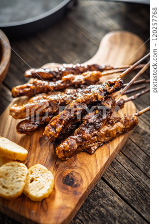 Japanese chicken yakitori on cutting board on wooden table. 120257768