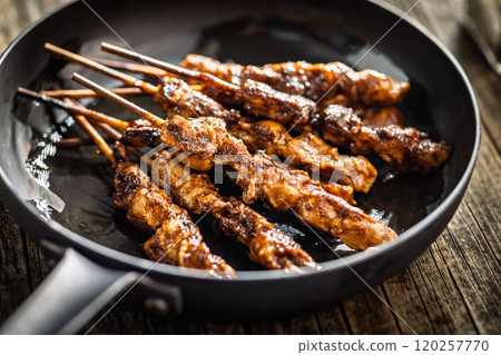 Japanese chicken yakitori on pan on wooden table. 120257770