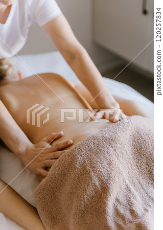 Relaxing back massage in a serene spa setting for ultimate wellness and rejuvenation Relaxing back massage in a serene spa setting for ultimate wellness and rejuvenation 120257834