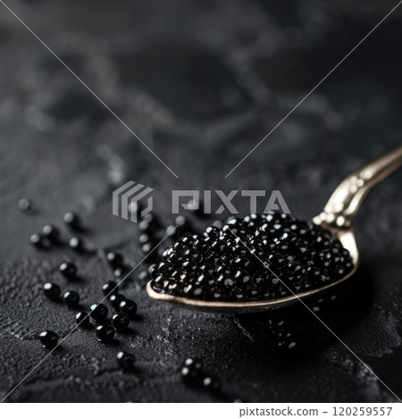 Silver Spoon Filled with Black Caviar on a Dark Surface 120259557