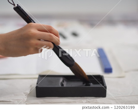 Calligraphy (child's hand holding a large brush) Calligraphy (child's hand holding a large brush) 120263199