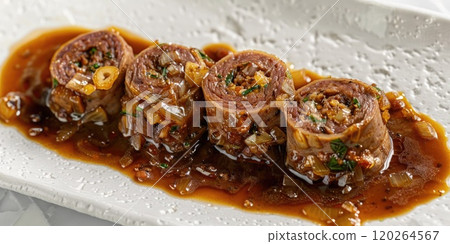 Beef Olives, a traditional Scottish dish consisting of thin slices of beef rolled around a stuffing of savory ingredients such as sausage meat, onions, and herbs, cooked in a rich gravy on white 120264567