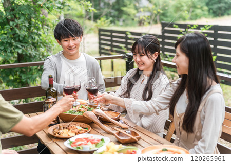 Young Asian couple having a home party glamping on a wooden deck Young Asian couple having a home party glamping on a wooden deck 120265961