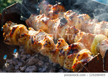 Grilled kebab cooking on metal skewer. Roasted meat cooked at barbecue.Traditional eastern dish, shish kebab. Grill on charcoal and flame, picnic, street food Grilled kebab cooking on metal skewer. Roasted meat cooked at barbecue.Traditional eastern dish, shish kebab. Grill on charcoal and flame, picnic, street food 120266405