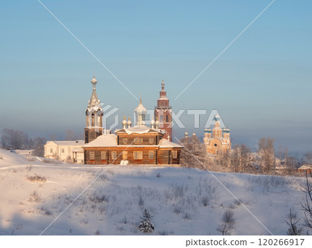 Frosty sunny afternoon over an ancient wooden temple. 120266917