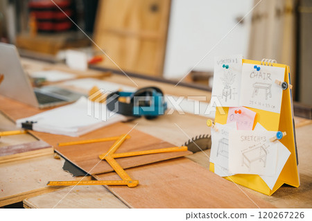 Yellow notepad with hand-drawn sketches of a chair and table, pinned to it. Ideal for showcasing furniture design, sketch style drawings, carpenter creative concept development 120267226