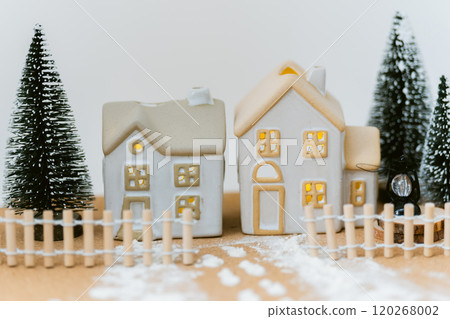 Small house and fence surrounded by snow - winter fantasy with warm lights Small house and fence surrounded by snow - winter fantasy with warm lights 120268002
