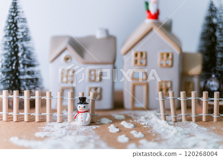 Winter scene of a little house decorated with snowman and Santa - warm lights and wooden fence Winter scene of a little house decorated with snowman and Santa - warm lights and wooden fence 120268004