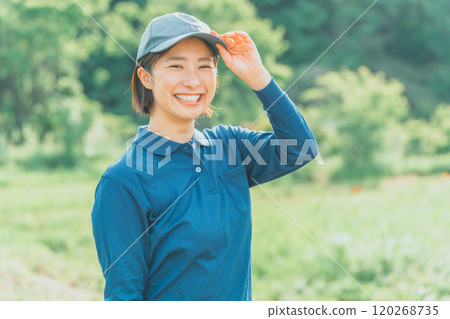 A working woman wearing a blue polo shirt and a blue cap 120268735