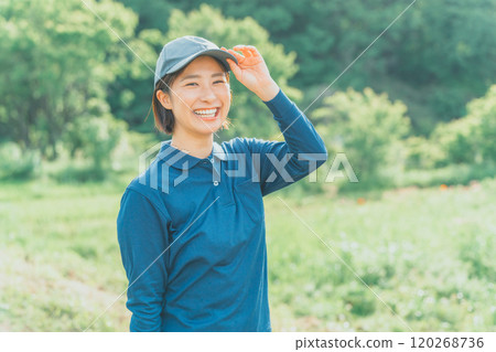 A working woman wearing a blue polo shirt and a blue cap A working woman wearing a blue polo shirt and a blue cap 120268736