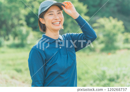 A working woman wearing a blue polo shirt and a blue cap 120268737