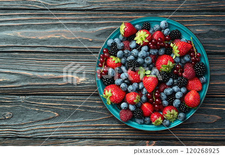 Mix of ripe colorful berries in bowl photography . Blueberry , strawberry , raspberry , blackberry and red currant . Top view Mix of ripe colorful berries in bowl photography . Blueberry , strawberry , raspberry , blackberry and red currant . Top view 120268925