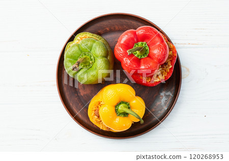 Baked stuffed pepper ( paprika ) with rice , carrot and meat . Top view on rustic background Baked stuffed pepper ( paprika ) with rice , carrot and meat . Top view on rustic background 120268953