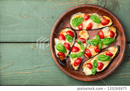 Italian mini pizza . Aubergine (eggplant ) with mozzarella cheese and basil . On rustic background 120268975
