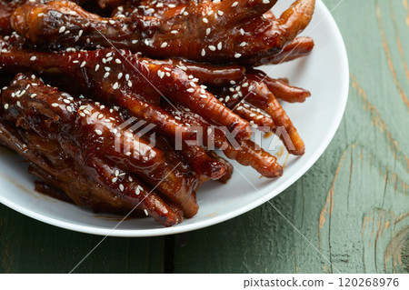 Caramelized korean or Chinese chicken foots ( paws ) with sesame . Top view 120268976