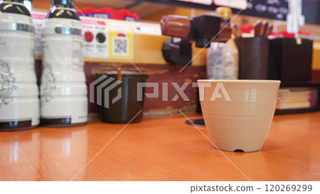 Hot water dispenser and teacups installed at a conveyor-belt sushi restaurant Hot water dispenser and teacups installed at a conveyor-belt sushi restaurant 120269299