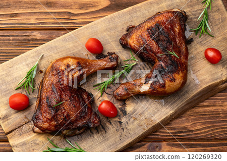 Grilled chicken legs with tomatoes and salad . Top view Grilled chicken legs with tomatoes and salad . Top view 120269320