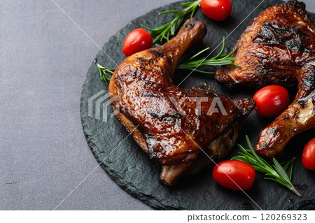 Grilled chicken legs with tomatoes and salad . Top view Grilled chicken legs with tomatoes and salad . Top view 120269323