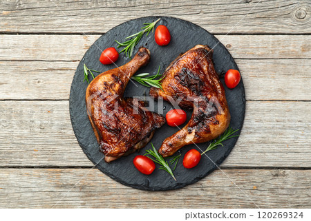 Grilled chicken legs with tomatoes and salad . Top view Grilled chicken legs with tomatoes and salad . Top view 120269324