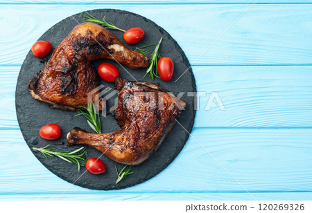 Grilled chicken legs with tomatoes and salad . Top view Grilled chicken legs with tomatoes and salad . Top view 120269326
