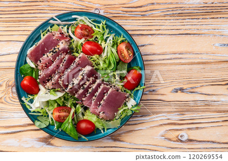 Salad with raw tuna , sesame and cherry tomatoes photography . Top view Salad with raw tuna , sesame and cherry tomatoes photography . Top view 120269554