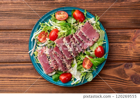 Salad with raw tuna , sesame and cherry tomatoes photography . Top view 120269555