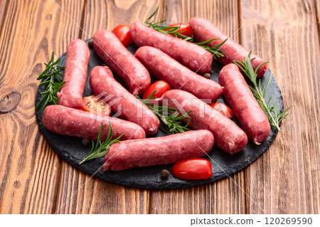 Raw beef sausages with rosemary and tomatoes photography . Top view Raw beef sausages with rosemary and tomatoes photography . Top view 120269590