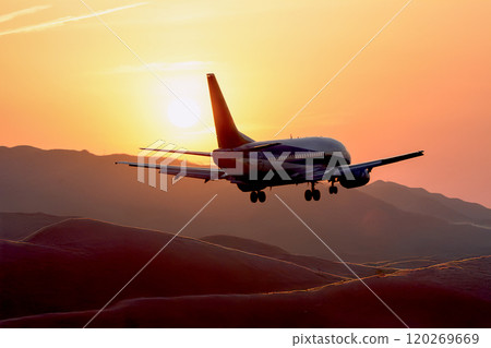 An airplane in the sunset, a passenger plane taking off from the desert sky An airplane in the sunset, a passenger plane taking off from the desert sky 120269669