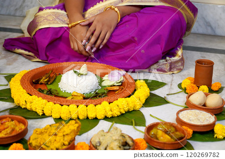 Bride taking aiburobhat from her family with different types of delicious bengali food items before marriage 120269782