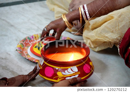 Performing ritual by bride at Indian Bengali Wedding 120270212