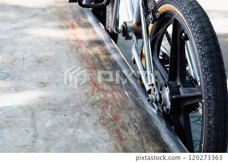 Close up of bmx bike on a ramp in a skatepark 120273363